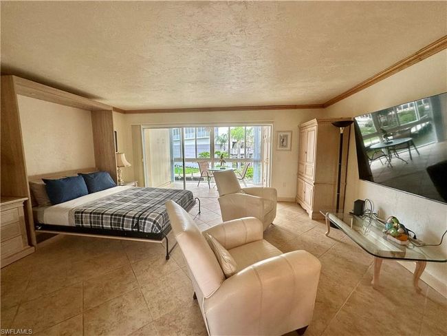 The conditioned Lanai opens into the living room creating a larger, wide open living space | Image 10