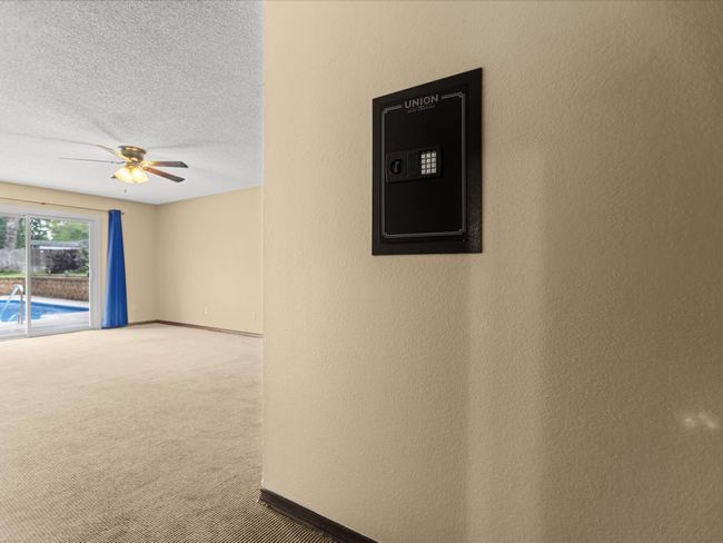 Master Bedroom with carpet flooring, ceiling fan, baseboards, a textured ceiling, and a textured wall | Image 24