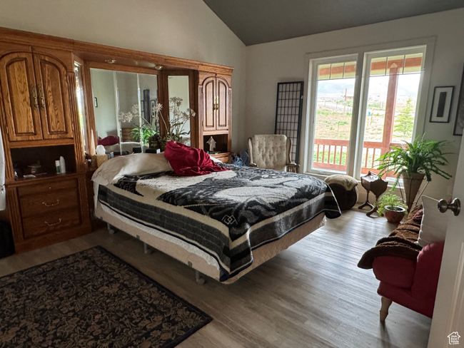 Bedroom with vaulted ceiling and wood finished floors | Image 14
