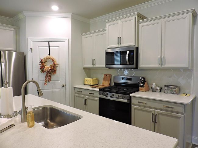 Kitchen with stainless steel appliances, a sink, crown molding, and recessed lighting | Image 5