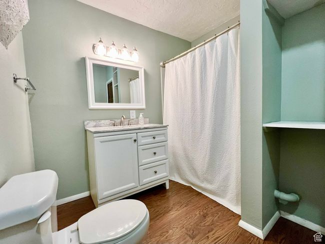 Full bath with baseboards, wood finished floors, toilet, and vanity | Image 17