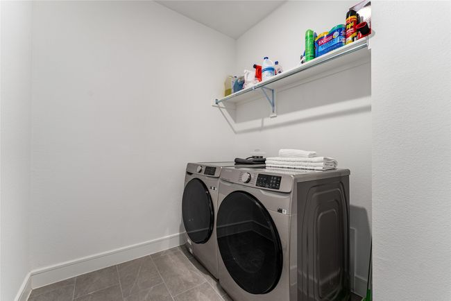 Laundry area with separate washer and dryer and tile patterned floors | Image 34