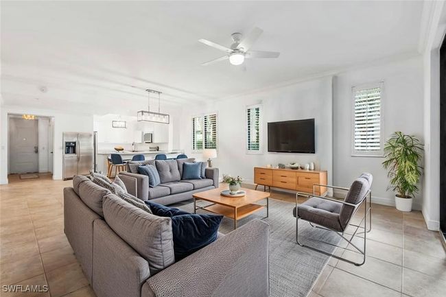 Virtually Staged: Living room featuring a healthy amount of sunlight, baseboards, ceiling fan, and light tile patterned flooring | Image 7