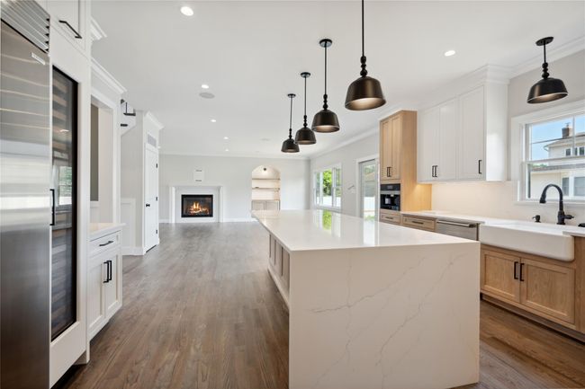 Kitchen featuring open floor plan, stainless steel appliances, recessed lighting, dark wood-type flooring, and hanging light fixtures | Image 12
