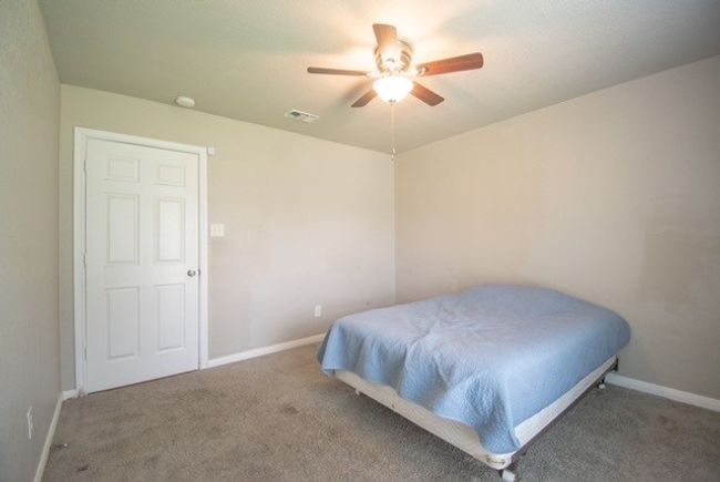 Carpeted bedroom with baseboards and a ceiling fan | Image 11