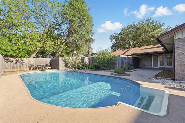 View of swimming pool with french doors, a patio area, a fenced in pool, and a fenced backyard | Image 30