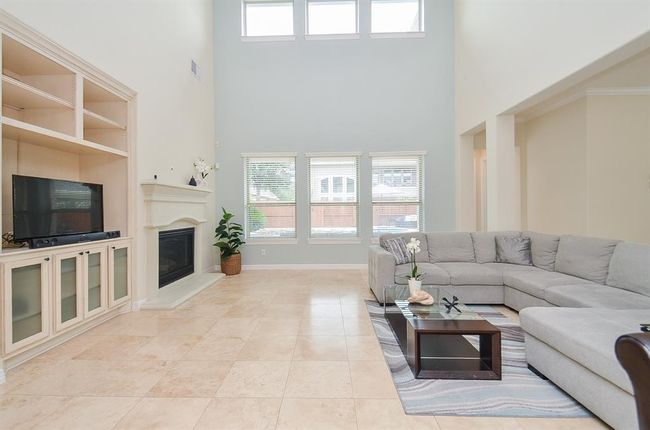 Gas log fireplace and built-in in family room. | Image 12