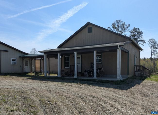 Cottage has covered walkway to the barn | Image 15