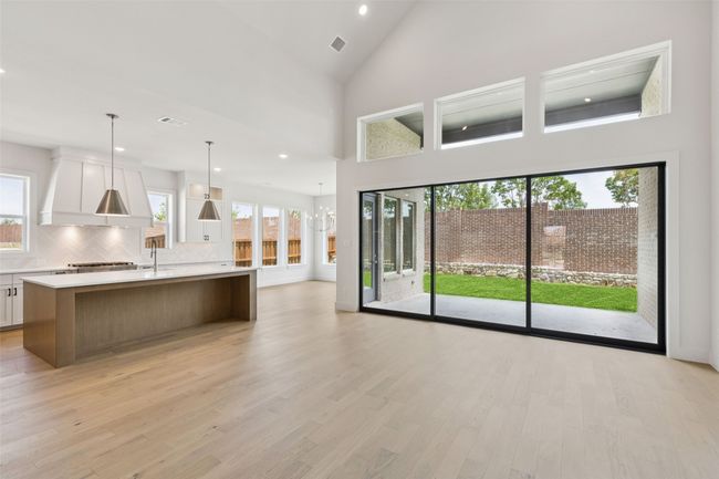 A spacious family room featuring a wall of windows is only one of the fantastic design elements in this dream home! | Image 7