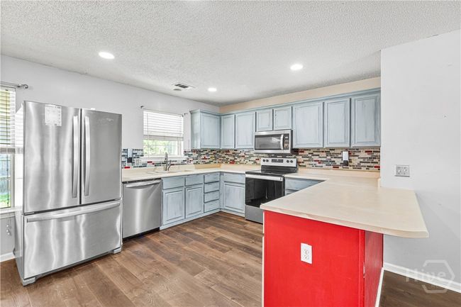 Kitchen offers ample cabinet space | Image 10