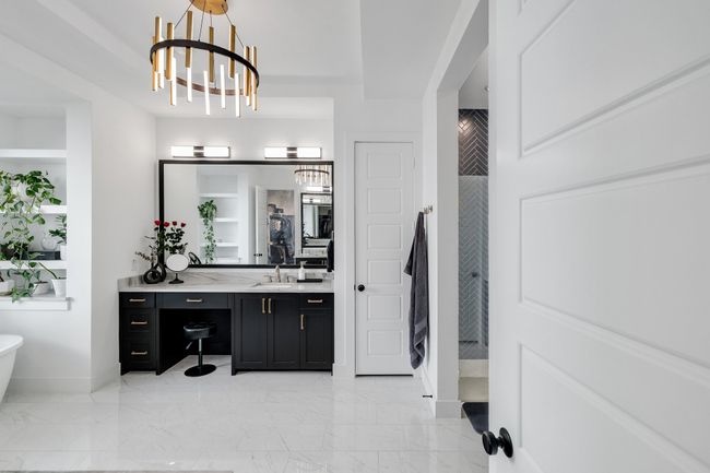 Full bathroom with vanity, a stall shower, a chandelier, marble finish flooring, and baseboards | Image 20