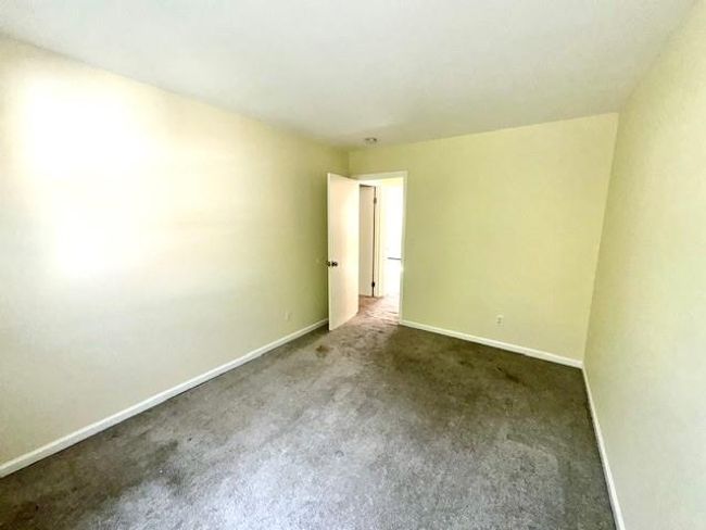 Spare room featuring carpet floors and baseboards | Image 10