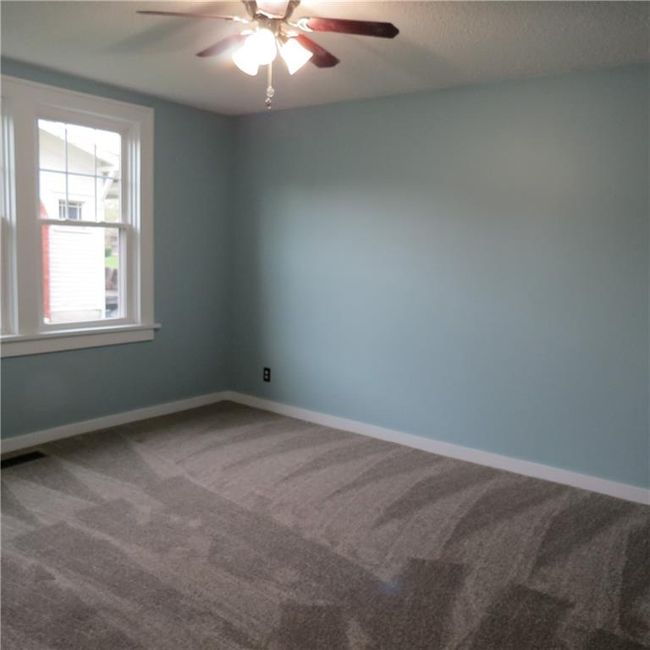 Unfurnished room with a ceiling fan, carpet flooring, and baseboards | Image 11
