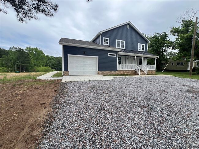 View of front of property with a porch, a garage, and driveway | Image 35