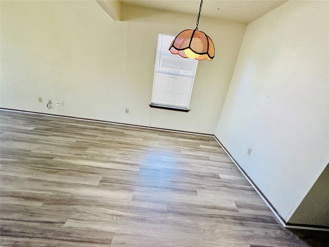 Unfurnished dining area with wood finished floors and a textured ceiling | Image 15