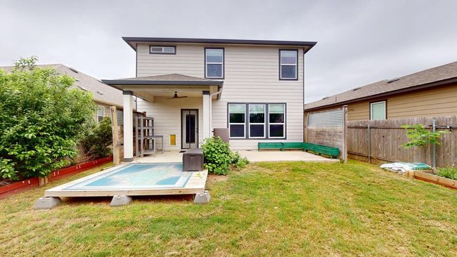 Back of property featuring a ceiling fan, a lawn, a deck, a fenced backyard, and a patio | Image 38
