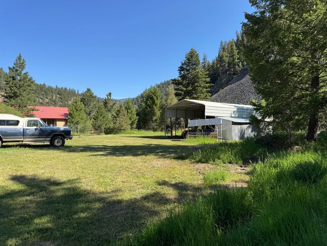 View of green lawn with a detached carport and a view of trees | Image 29