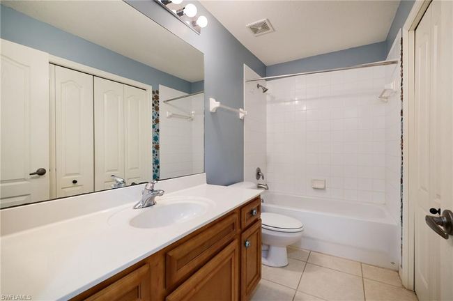 Bathroom with vanity, shower combination, and tile patterned floors | Image 8