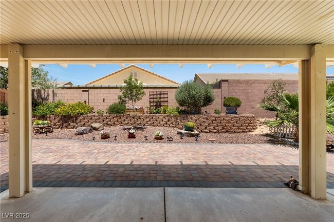 Fenced backyard with a patio | Image 37