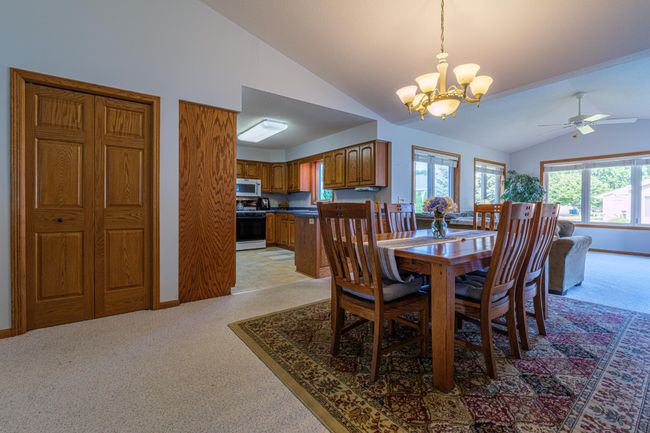 Dining room with vaulted ceilings. | Image 7