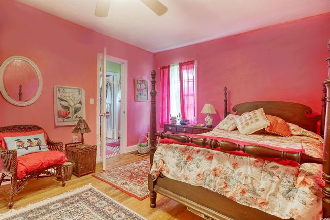 Bedroom with wood finished floors and a ceiling fan | Image 23