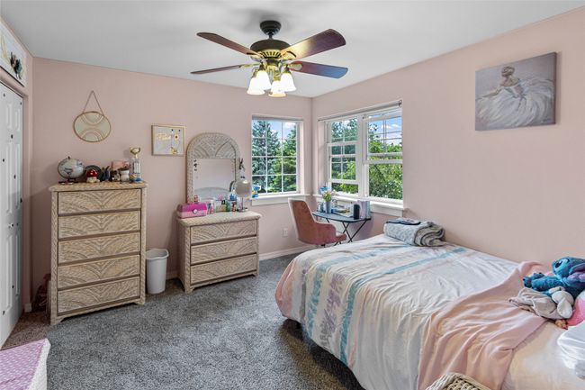 Carpeted bedroom with ceiling fan and baseboards | Image 42