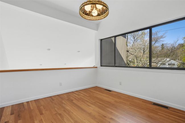 Home office, bonus room, loft is filled with light and offers dramatic views of the living room below. | Image 22