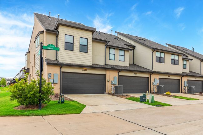 View of property with a garage, driveway, a shingled roof, and stucco siding | Image 30