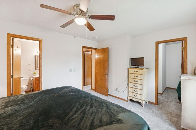 The primary bedroom offers a walk-in closet, and direct access to the walk-thru upper level bathroom. | Image 12
