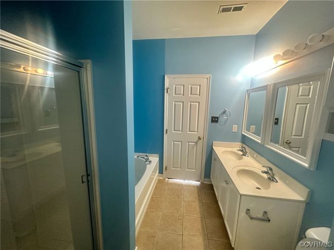 Bathroom featuring double vanity, independent shower and bath, and tile flooring | Image 18