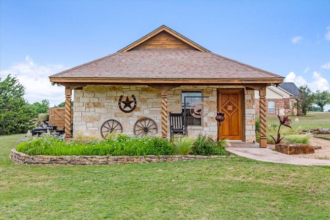 View of front of house featuring stone siding and a front yard | Image 33