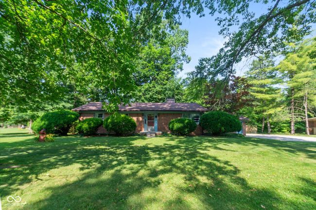 ranch-style home featuring a front yard, brick siding, and a chimney | Image 4