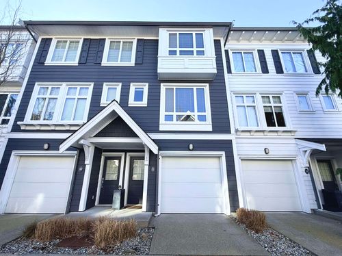 View of front facade with an attached garage and driveway | Card Image