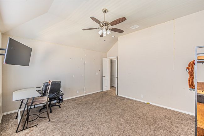 Office area with lofted ceiling, carpet flooring, ceiling fan, and baseboards | Image 31
