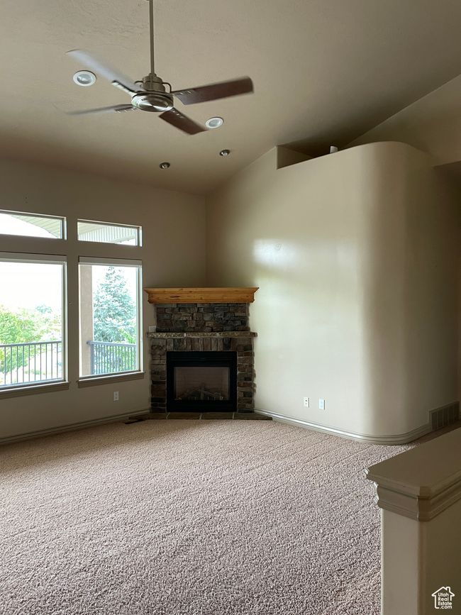 Unfurnished living room featuring carpet, a ceiling fan, a fireplace, and recessed lighting | Image 9
