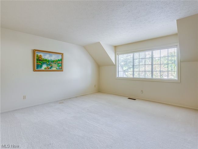 Empty room with a textured ceiling and light carpet | Image 24