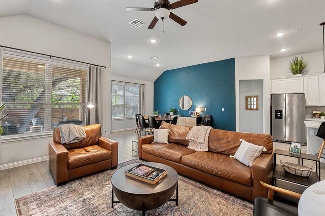 Living room featuring vaulted ceiling, light wood-type flooring, ceiling fan, and recessed lighting | Image 8