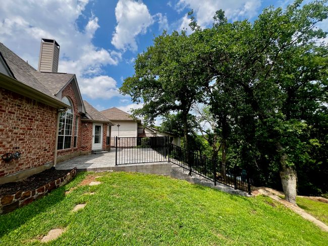 View of yard with a patio area and fence | Image 31