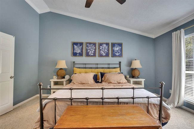 Carpeted bedroom with lofted ceiling, baseboards, ornamental molding, and a ceiling fan | Image 21