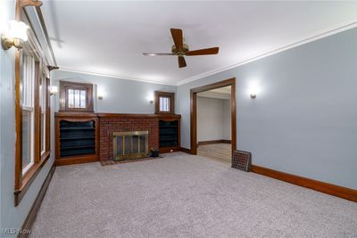 Living room wood burning fireplace and built-in bookcases | Image 3