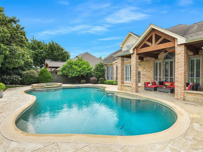 View of pool featuring a patio area, an outdoor living space, ceiling fan, and a pool with connected hot tub | Image 40