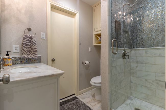 Bathroom with a stall shower, toilet, and vanity | Image 19