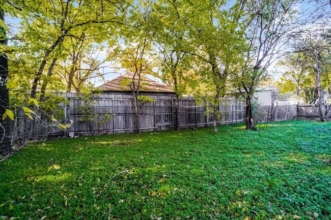 View of fenced backyard | Image 25