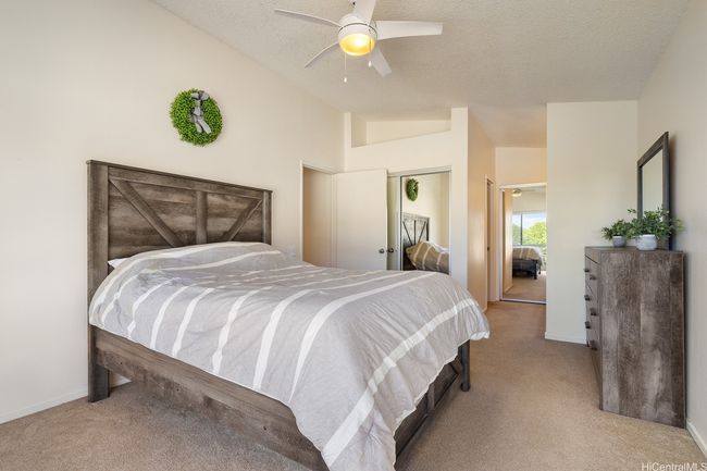 Spacious primary bedroom with en suite bathroom provides privacy and room to spread out. | Image 19