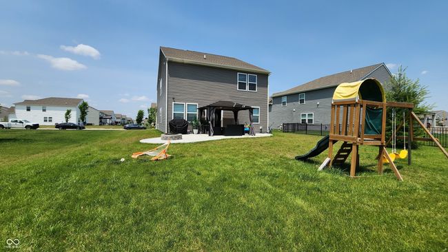 back of property featuring a playground, a patio, and a gazebo | Image 24