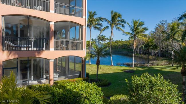 Rear view of house featuring a water view and a lawn | Image 21