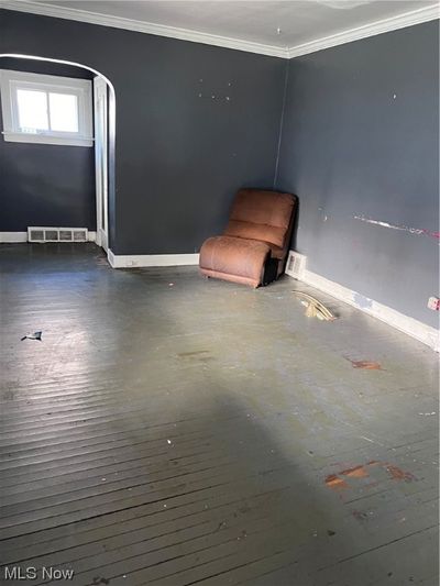 Unfurnished room with dark wood-type flooring and ornamental molding | Image 3