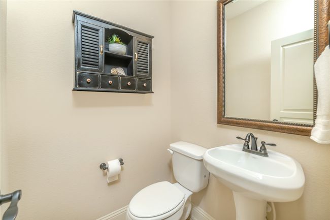 Bathroom with baseboards, toilet, and a sink | Image 20
