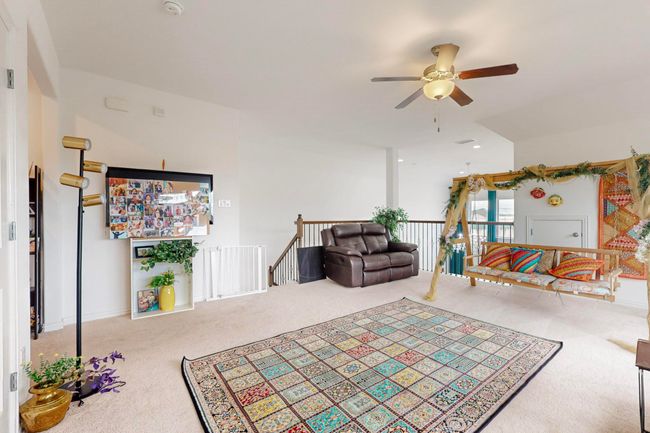 Living area with ceiling fan and carpet | Image 26