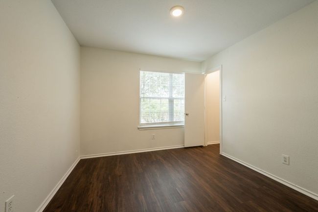Empty room with dark wood finished floors and baseboards | Image 28